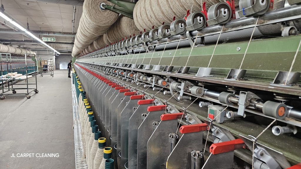 Wool fibres are being spun into bobbins
